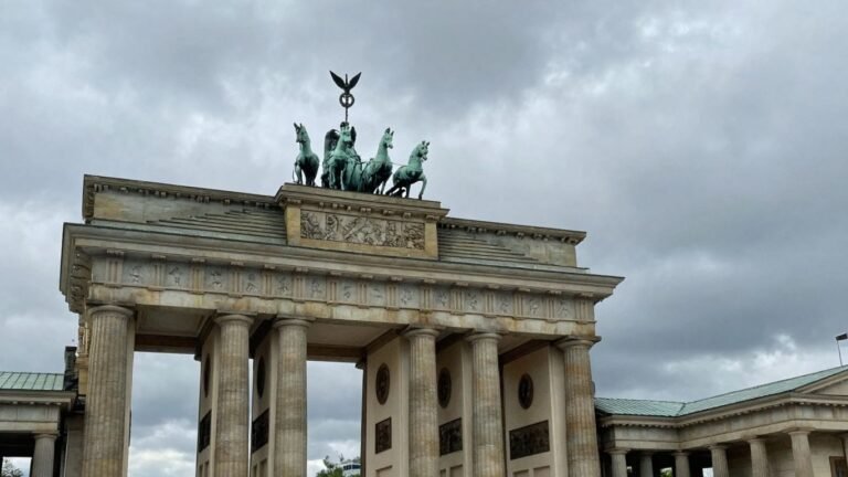 Brandenburg Gate under a cloudy sky in Germany.