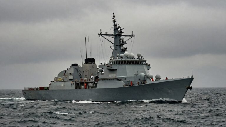US military boat on water, foggy background.