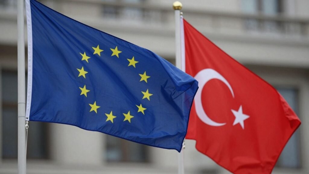 EU and Turkish flags waving together outdoors.