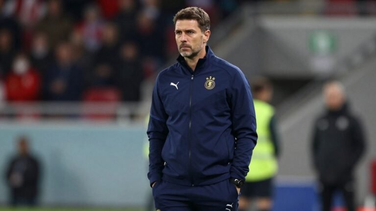 Motherwell manager on a football pitch.