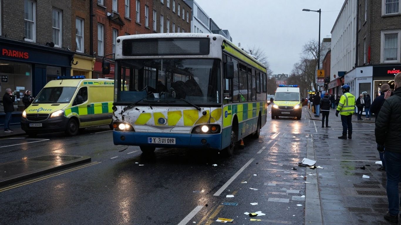 Bus crash scene in Dublin city center with emergency services.
