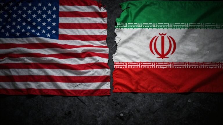 US and Iran flags facing each other, global tension.