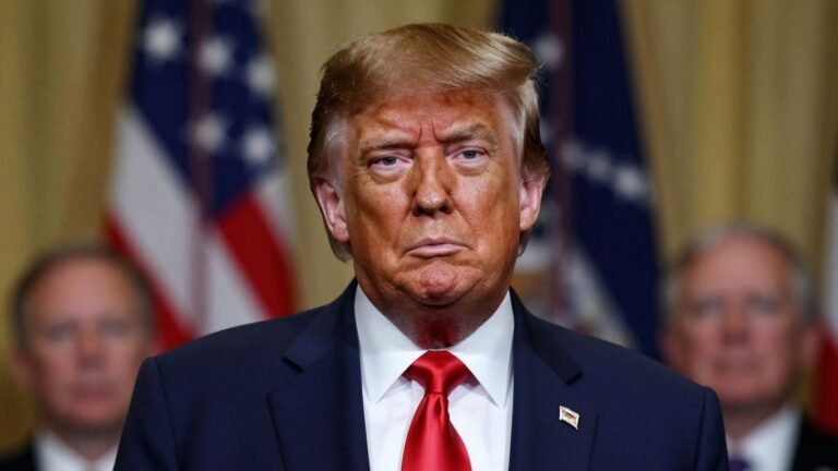 [Donald Trump] in a formal setting, looking at the camera.