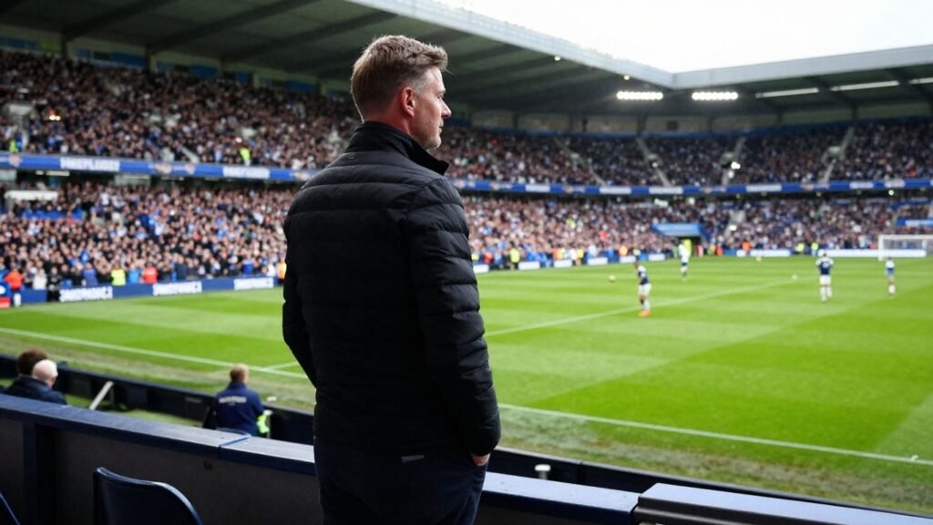 David Moyes on a football pitch with fans.