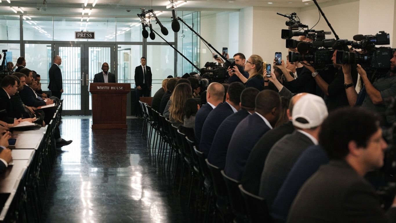 Reporters and cameras gather inside a tense White House press room.
